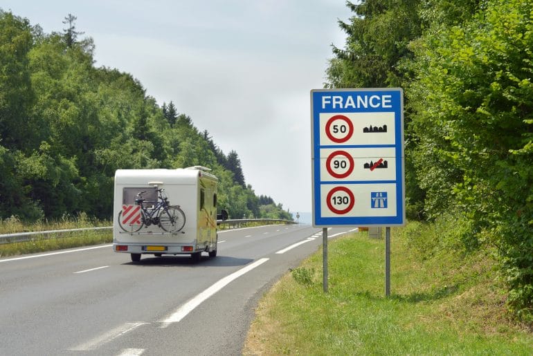 Camper,Passing,The,Sign,Of,Speed,Limits,At,The,French
